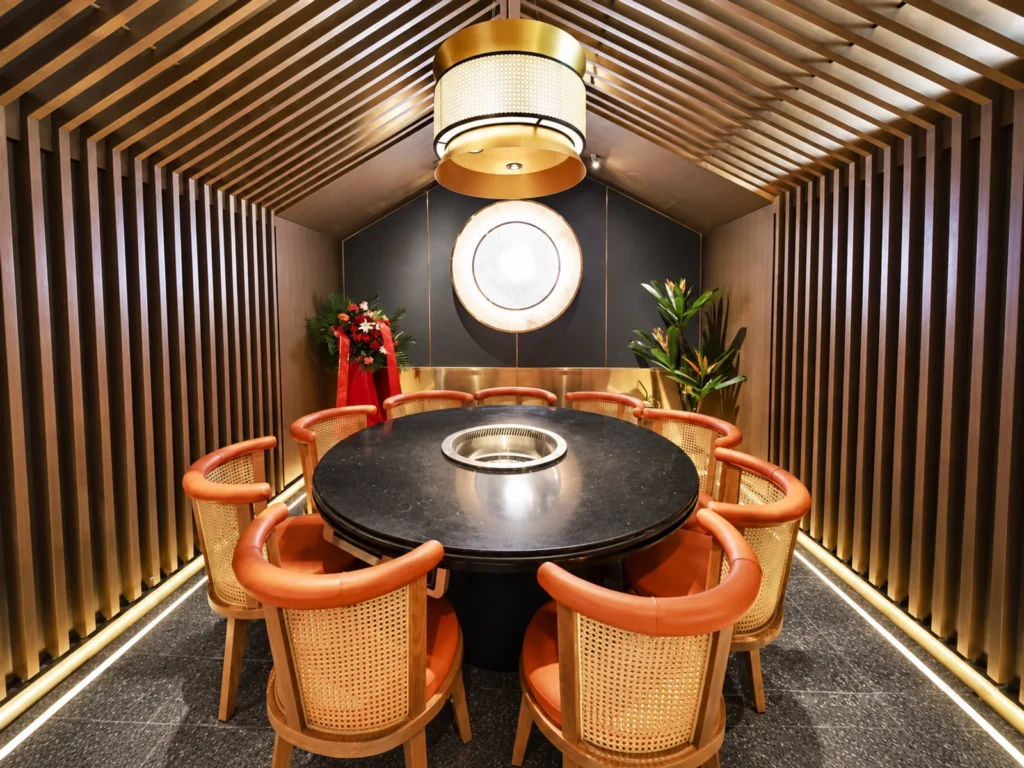 A round table setting carries the same warm tones into a group dining area.