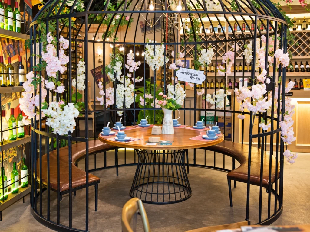 Cage-style seating area with round dining table in a themed restaurant.