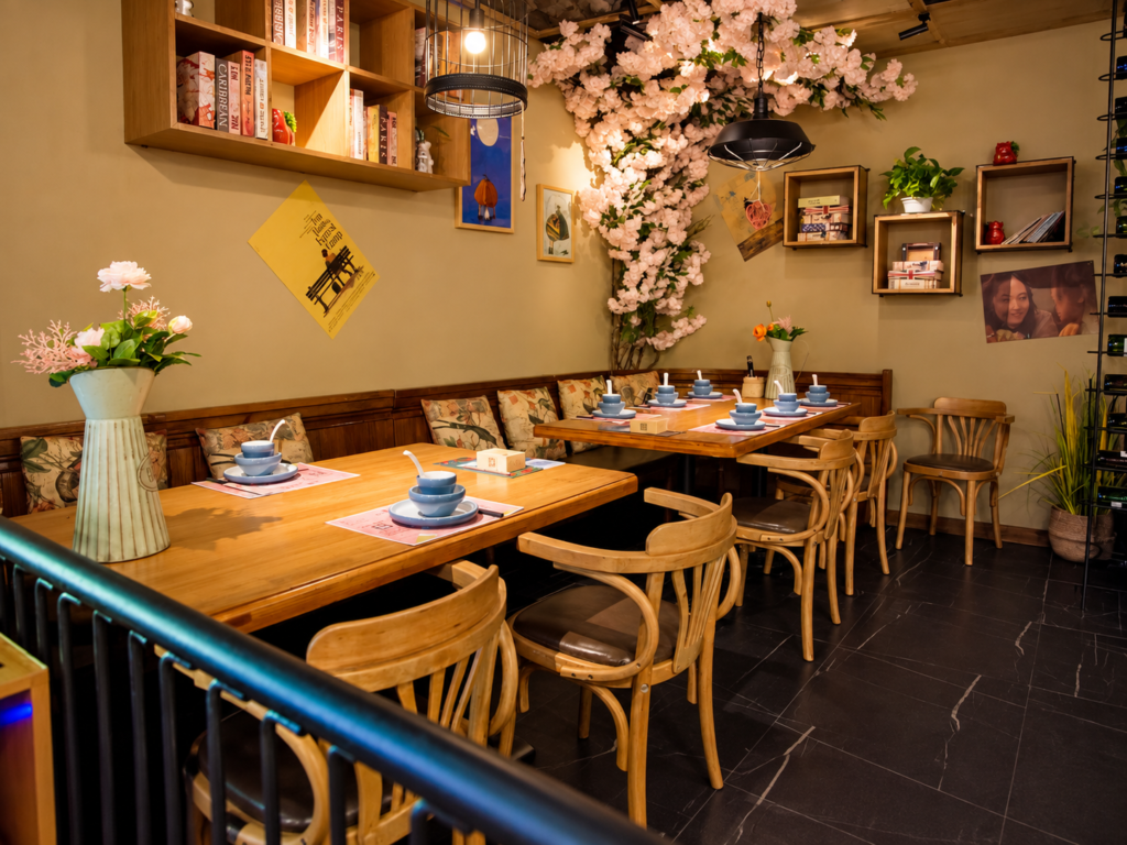 Floral themed restaurant dining area with wooden tables and classic chairs.